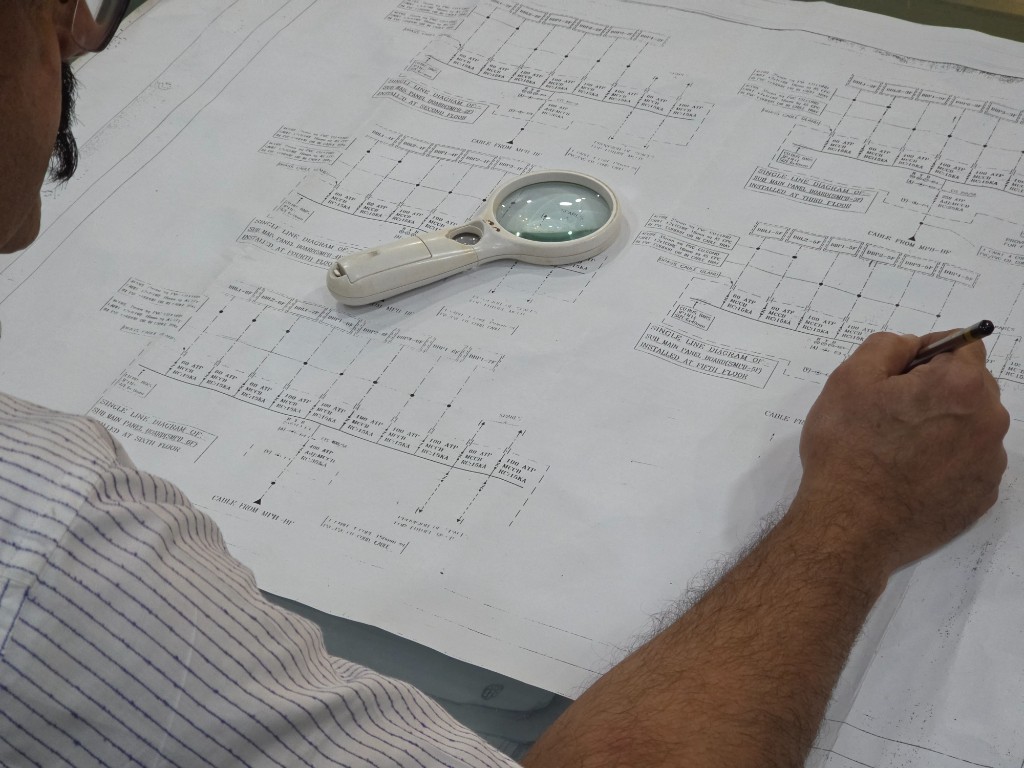 Engineer reviewing a single-line diagram for a panel board